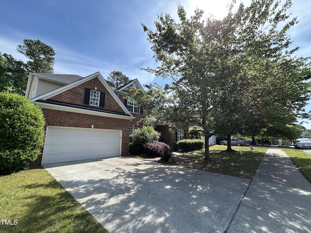 view of front of house with brick siding, driveway, and an attached garage