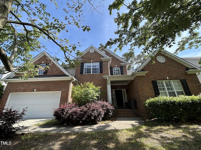 traditional-style home with brick siding and a garage