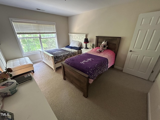 bedroom with carpet and baseboards