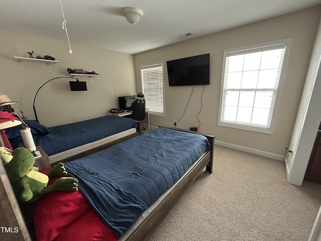 bedroom with carpet floors and baseboards