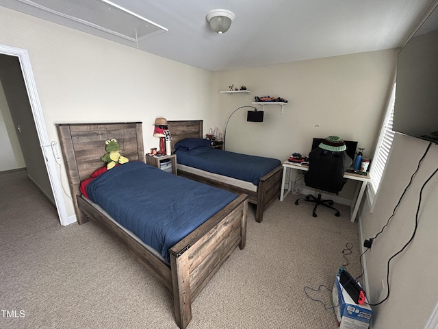 bedroom with attic access, carpet floors, and baseboards