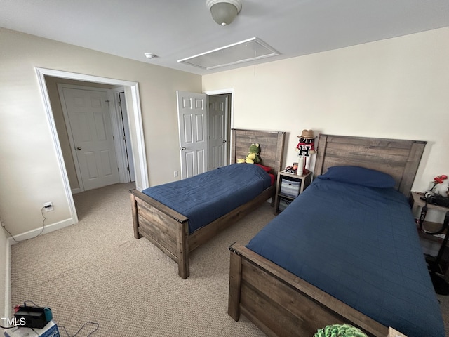 bedroom with attic access, carpet, and baseboards