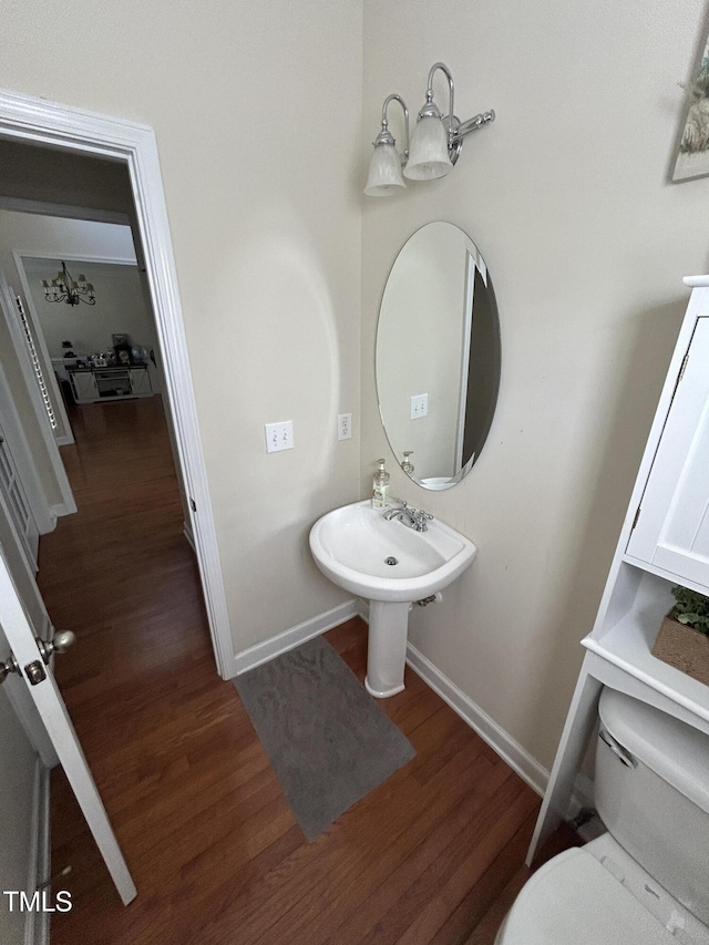 bathroom with wood finished floors and baseboards