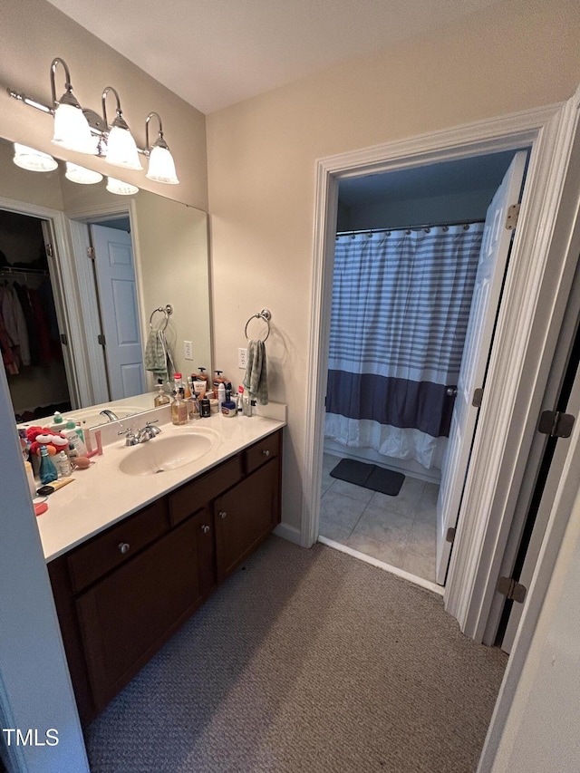 bathroom featuring vanity and a shower with shower curtain