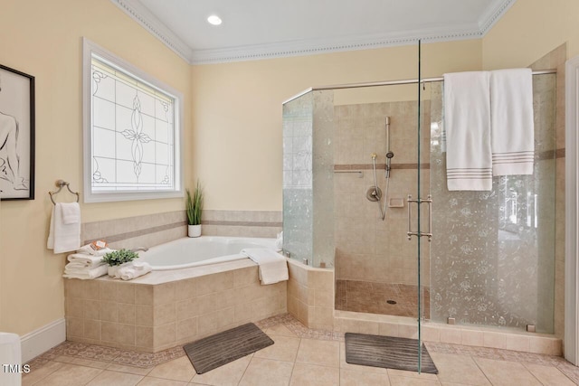 bathroom featuring tile patterned flooring, ornamental molding, a shower stall, and a garden tub