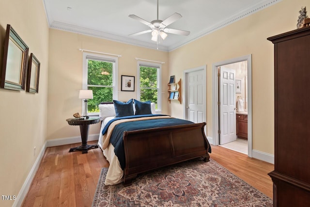 bedroom with baseboards, ornamental molding, and light wood-type flooring