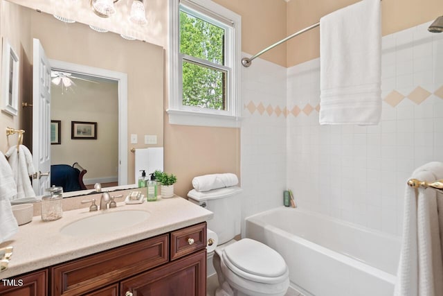 bathroom with vanity, a ceiling fan, toilet, and shower / tub combination