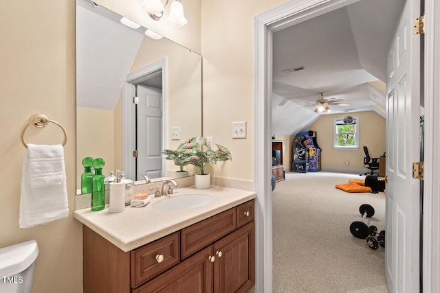 bathroom featuring vanity, ceiling fan, toilet, and lofted ceiling