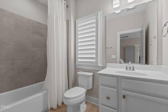 full bathroom featuring toilet, vanity, and shower / bath combination with curtain