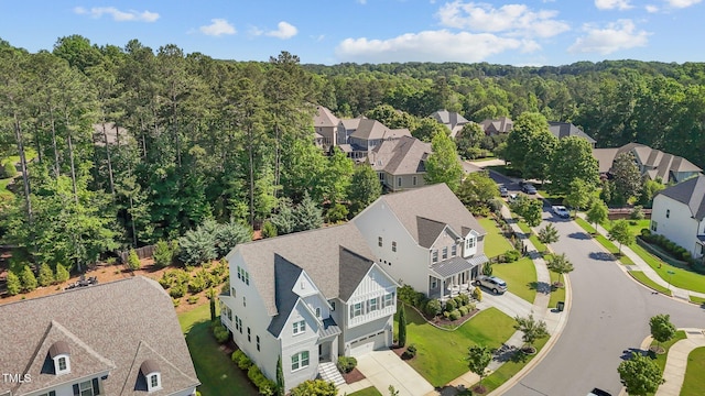 aerial perspective of suburban area featuring a forest
