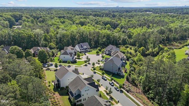 aerial view of residential area featuring a forest