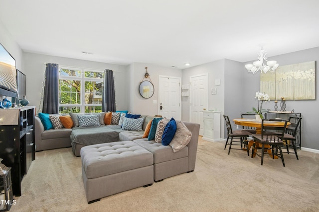 carpeted living room with an inviting chandelier, baseboards, and visible vents
