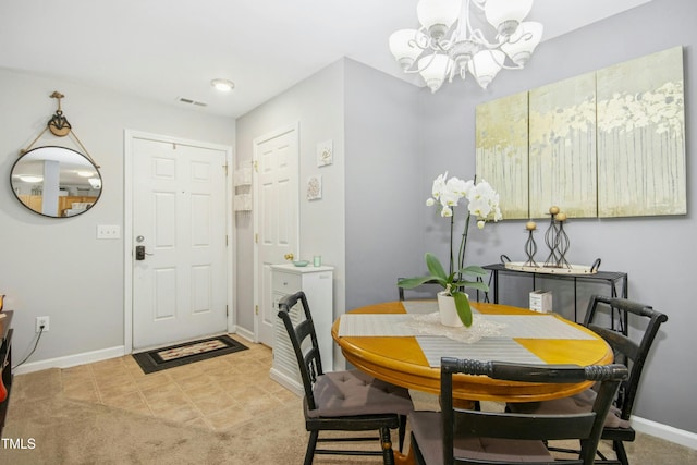 dining space featuring an inviting chandelier, baseboards, and visible vents