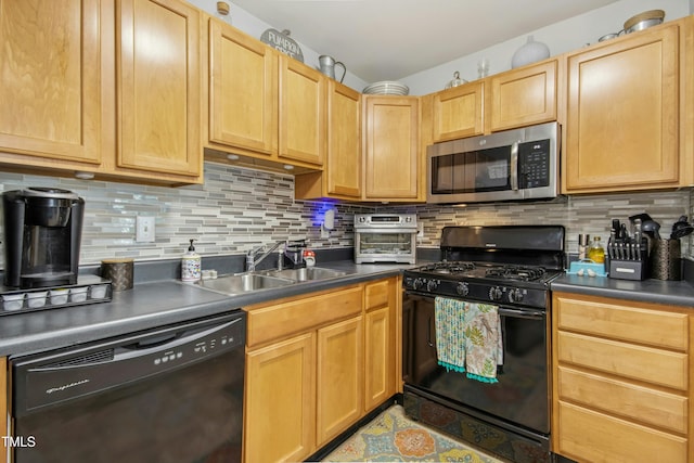 kitchen featuring backsplash, dark countertops, a sink, and black appliances