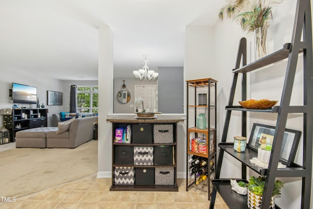 interior space with an inviting chandelier and carpet flooring