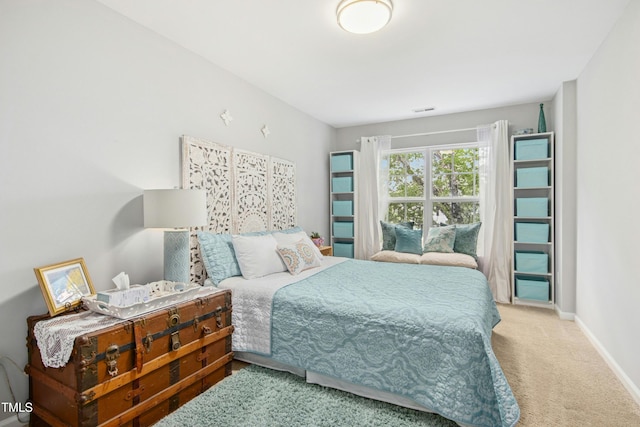 carpeted bedroom with baseboards and visible vents
