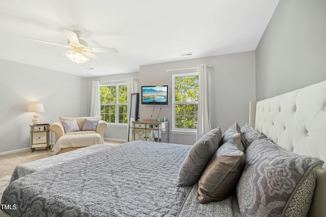 carpeted bedroom featuring a ceiling fan, baseboards, and visible vents
