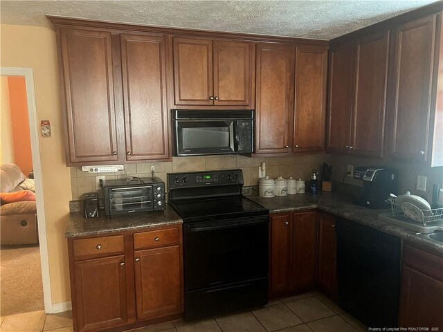 3418 Rudland Ct, Fayetteville, NC 28304 - kitchen featuring black appliances, light tile patterned flooring, decorative backsplash, and a textured ceiling