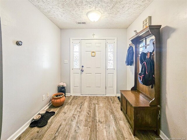 6314 Greycliff Dr, Fayetteville, NC 28314 - entryway featuring light wood-style flooring, a textured ceiling, and baseboards
