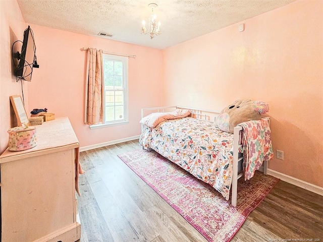 6314 Greycliff Dr, Fayetteville, NC 28314 - bedroom with wood finished floors, a chandelier, a textured ceiling, and baseboards