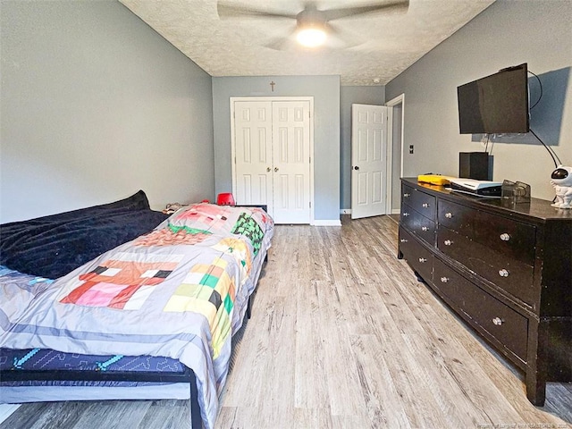 6314 Greycliff Dr, Fayetteville, NC 28314 - bedroom with light wood-style floors, a closet, baseboards, a ceiling fan, and a textured ceiling
