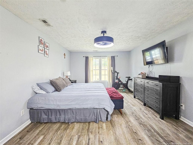6314 Greycliff Dr, Fayetteville, NC 28314 - bedroom featuring wood finished floors, baseboards, and a textured ceiling