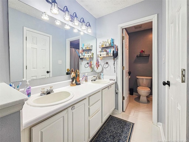 6314 Greycliff Dr, Fayetteville, NC 28314 - full bath featuring tile patterned flooring, double vanity, a textured ceiling, and toilet