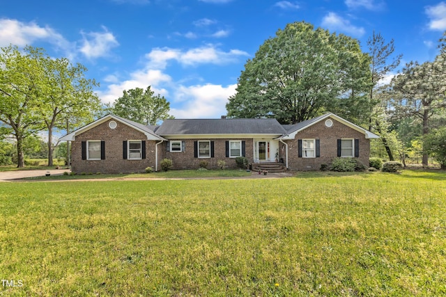 ranch-style house featuring brick siding and a front yard