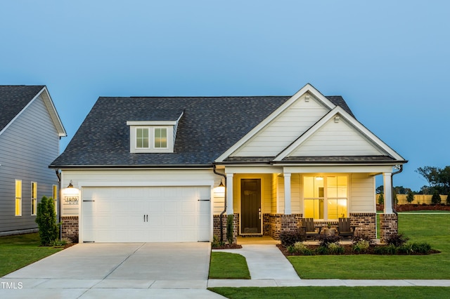 1606 Garden Park Cir, Fuquay Varina, NC 27526 - view of front facade featuring a front yard, driveway, covered porch, and brick siding