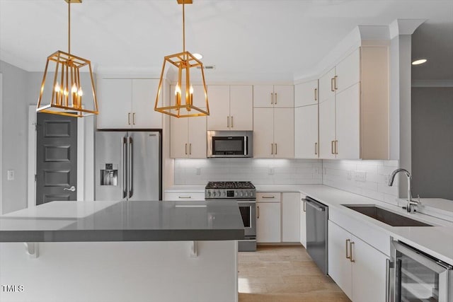 kitchen featuring stainless steel appliances, a sink, beverage cooler, a chandelier, and ornamental molding