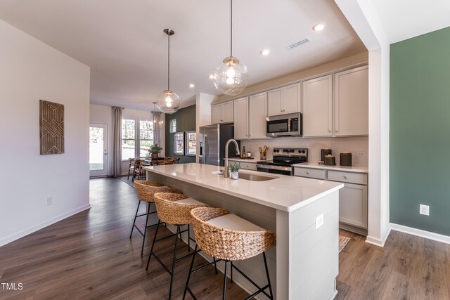 LOT5 Cooper St, Sanford, NC 27330 - kitchen featuring a sink, a kitchen bar, a center island with sink, visible vents, and appliances with stainless steel finishes