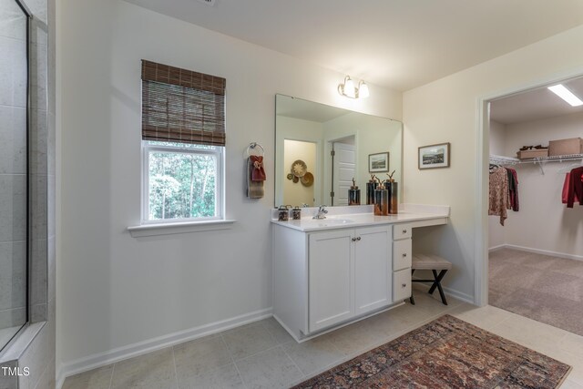 LOT5 Cooper St, Sanford, NC 27330 - bathroom with tile patterned floors, a walk in closet, vanity, and baseboards
