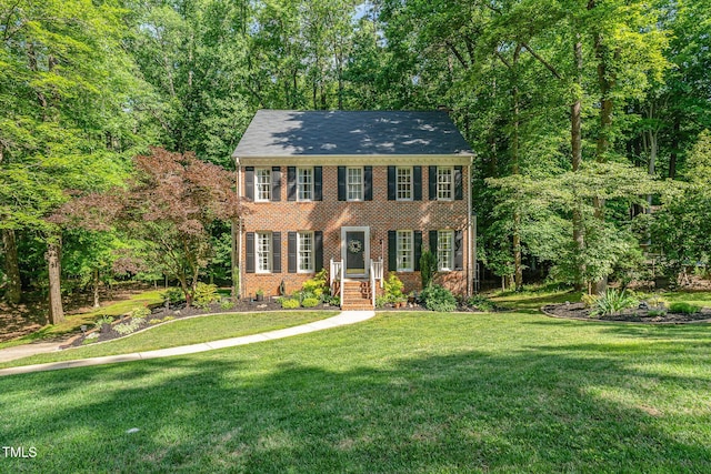 colonial-style house with brick siding and a front lawn