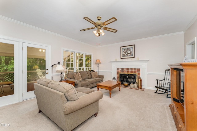 living room featuring a fireplace, light carpet, ceiling fan, and crown molding