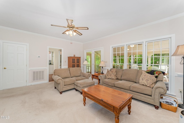 living area featuring crown molding, a ceiling fan, and carpet flooring
