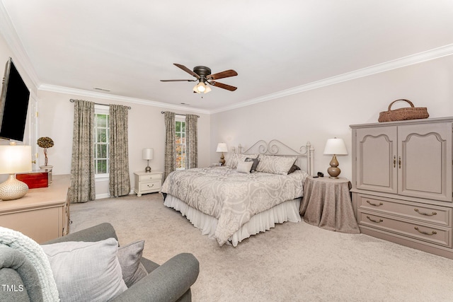 bedroom with crown molding, light carpet, and a ceiling fan