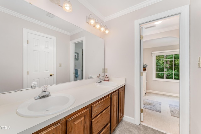 bathroom featuring crown molding, double vanity, and baseboards