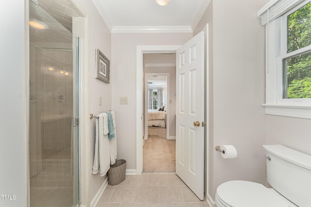 bathroom with toilet, plenty of natural light, a shower stall, and ornamental molding