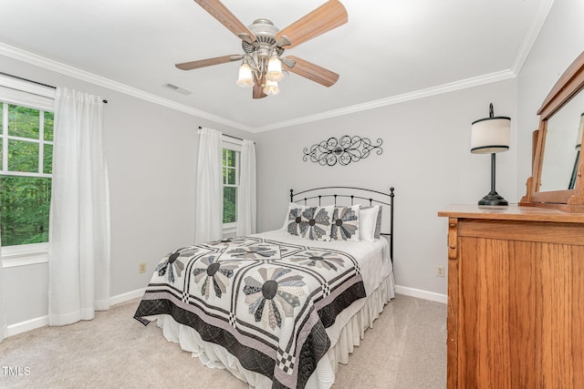 bedroom with light carpet, multiple windows, crown molding, baseboards, and ceiling fan