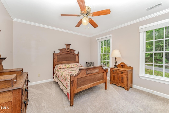 bedroom with baseboards, light carpet, crown molding, and ceiling fan