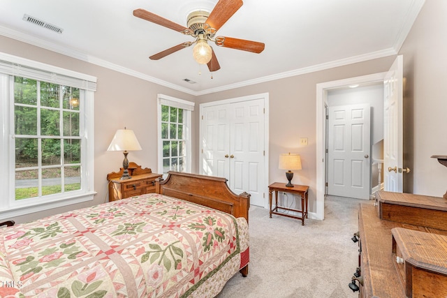 bedroom featuring light carpet, crown molding, a closet, and ceiling fan