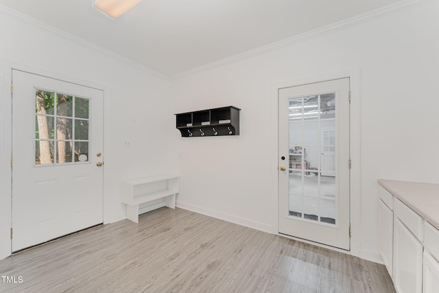 doorway featuring crown molding, light wood finished floors, and baseboards