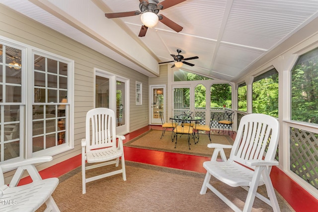 sunroom featuring ceiling fan and lofted ceiling
