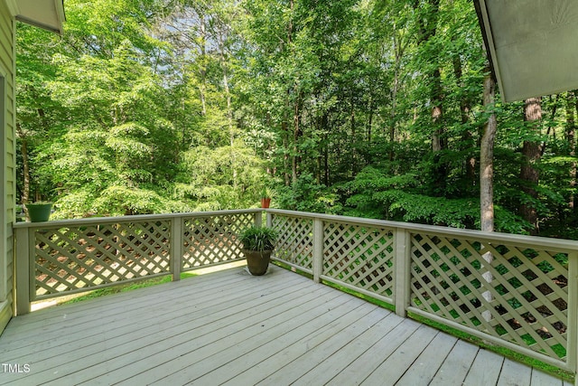 wooden deck featuring a forest view
