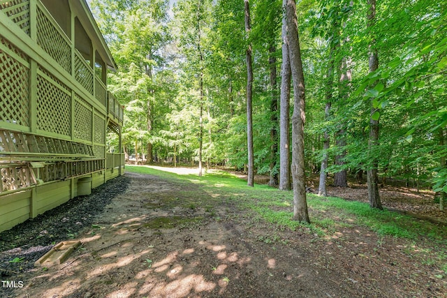 view of yard featuring a forest view