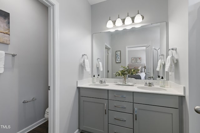 832 Oak Center Dr, Raleigh, NC 27610 - ensuite bathroom featuring toilet, double vanity, a sink, and ensuite bath