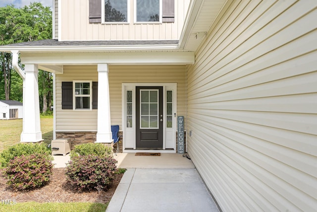 105 Forest Wood Dr, Salemburg, NC 28385 - view of exterior entry featuring a porch, board and batten siding, and stone siding