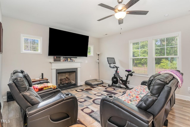 105 Forest Wood Dr, Salemburg, NC 28385 - living room featuring a ceiling fan, a fireplace with flush hearth, light wood-style floors, and plenty of natural light