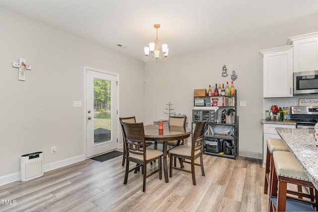 105 Forest Wood Dr, Salemburg, NC 28385 - dining space with an inviting chandelier, visible vents, light wood finished floors, and baseboards