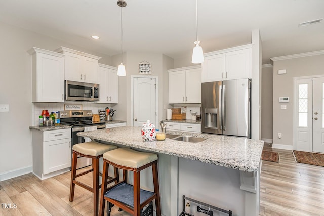 105 Forest Wood Dr, Salemburg, NC 28385 - kitchen featuring backsplash, light wood-style flooring, and stainless steel appliances